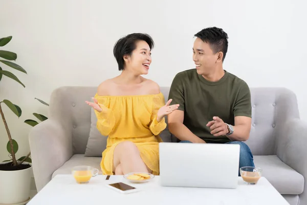 Young Asian Couple Home Sitting Sofa Using Laptop — стокове фото