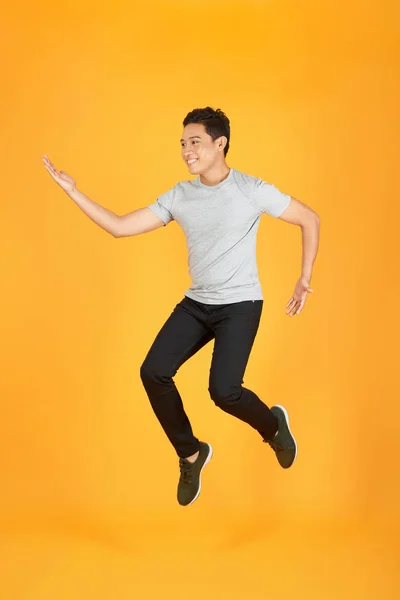 Energetic Happy Young Asian Man Casual Clothes Jumping Studio Shot — Stock Photo, Image