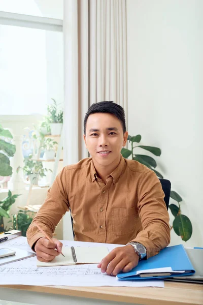 Portrait Smiling Young Businessman Working Blueprints Office — Stock Photo, Image