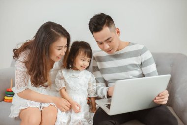 Aile evde dizüstü bilgisayar kullanıyor.