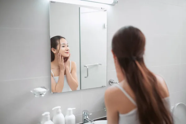 Young Woman Looking Mirror Examines Her Skin Touching Face Finger — Stock Photo, Image