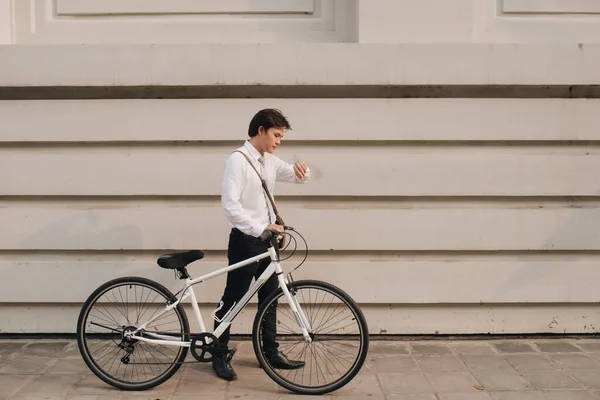 Businessman riding bicycle to work in town