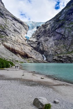 The Briksdalsbren glacier in Norway. The lake with clear water. clipart
