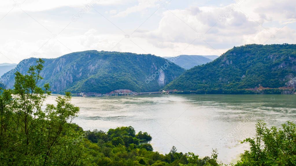 Sculpture bas-relief of the Dacian king Decebal, located on the rocky bank of the Danube in Romania, near the famous Iron Gate or Djerdap Gorge (Djerdap National Park). View from the coast of Serbia.