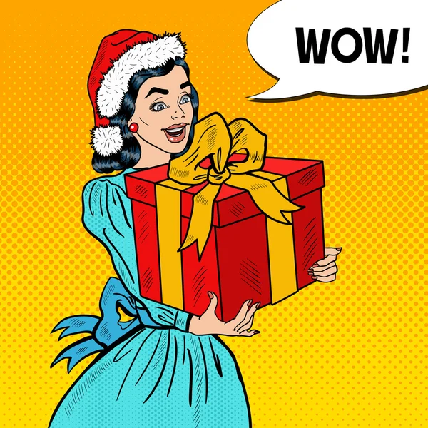 Pop Art Joven mujer feliz sosteniendo la caja de regalo de Navidad con la burbuja del discurso cómico. Ilustración vectorial — Vector de stock