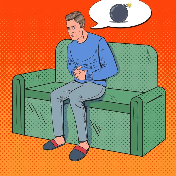 Pop Art Unhappy Man Hurts from Stomach Ache. El enfermo sentado en el sofá en casa. Ilustración vectorial — Archivo Imágenes Vectoriales