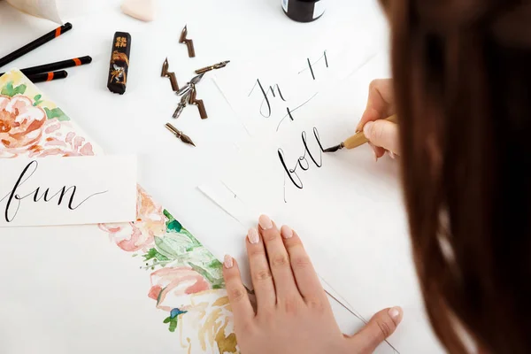 Girl writing calligraphy on postcards. Art design.