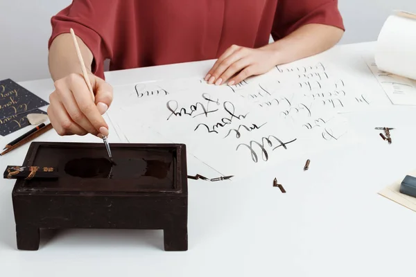 Girl writing calligraphy on postcards. Art design.