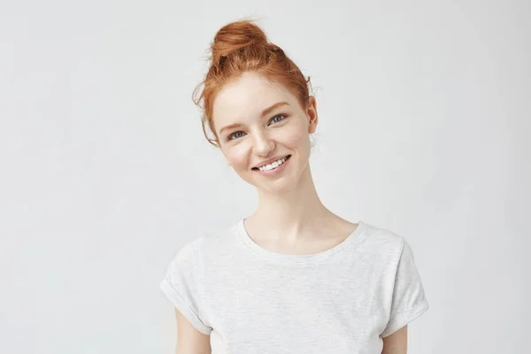 ginger girl with freckles smiling