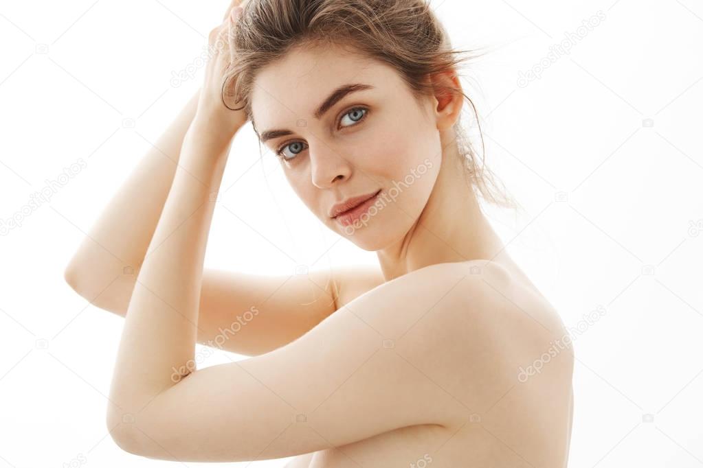 Portrait Of Young Attractive Tender Naked Girl With Bun Looking At 