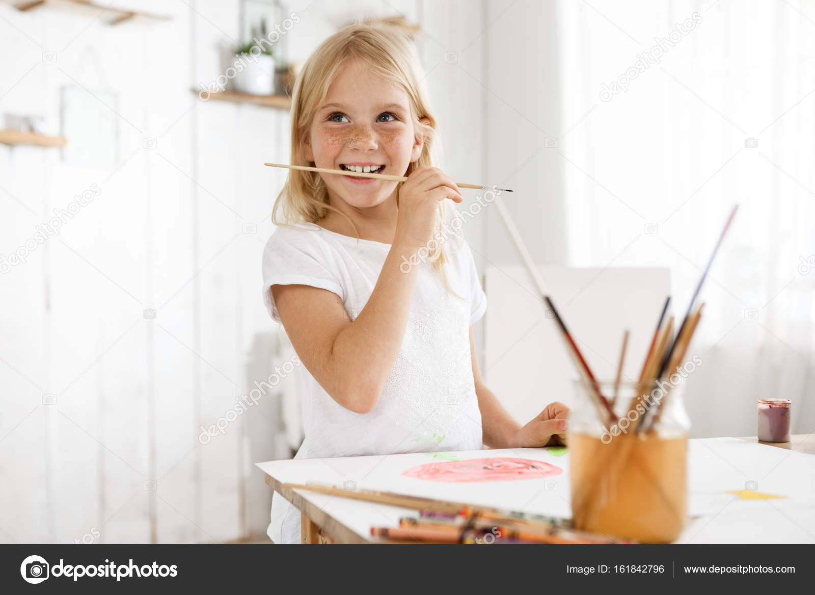 Little Girl With Blonde Hair And Freckles Enjoying Art Wearing