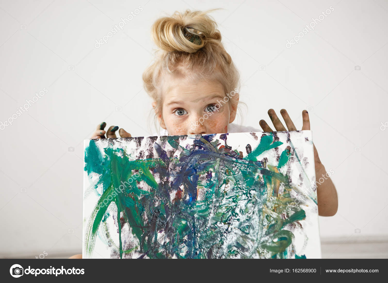 Close Up Portrait Of Blonde European Little Girl With Hair Bun And