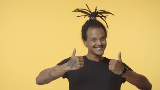 You Think Good But Its Awful Cheerful And Sassy Handsome Bearded Guy With Dreadlocks Tattoos Hipster African American Show Thumb Up And Smile Approval Than Change Mind Show Thumb Down Disapproval