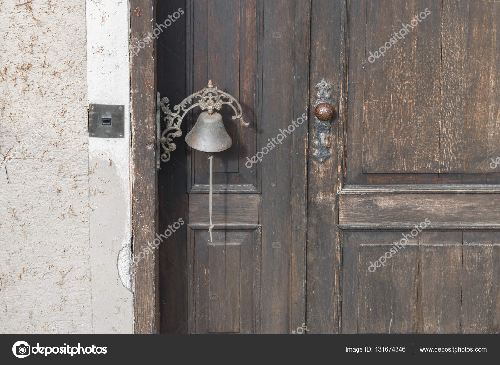 Old Door Bell On An Old Wooden Door Stock Photo