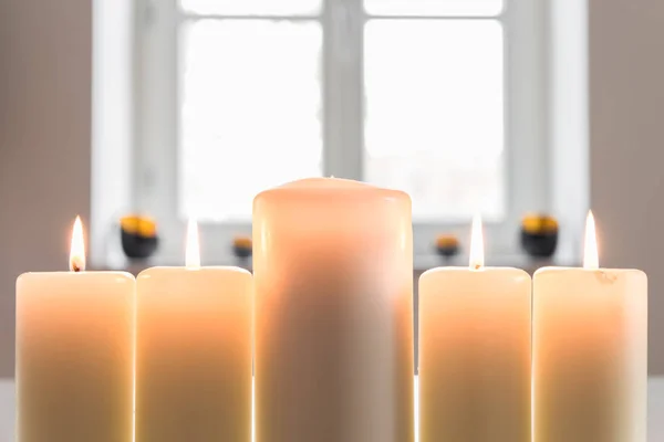 Closeup of a white burning candles — Stock Photo, Image