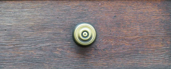 Vintage door handle on a wooden front door