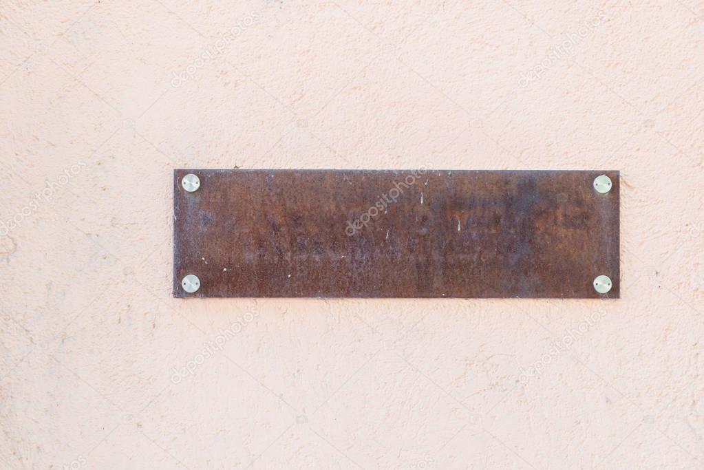 Empty rusty iron name plate 