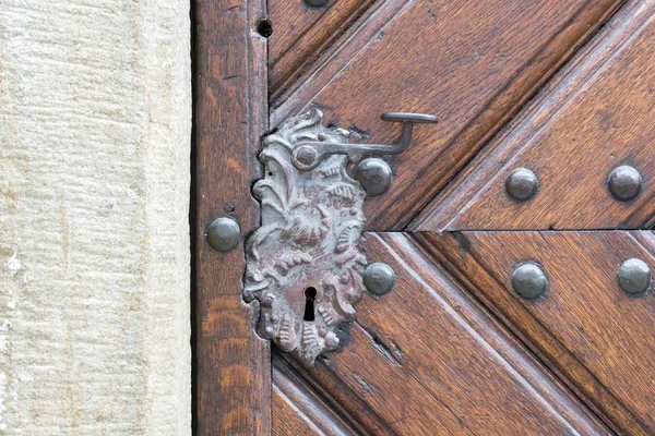 Vintage door handle on a wooden front door