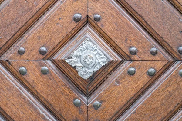 Vintage door handle on a wooden front door
