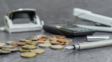 Bir masa üzerine para ve ofis aksesuarları