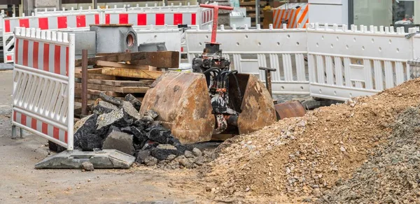 Barrier and excavator shovel on a construction site