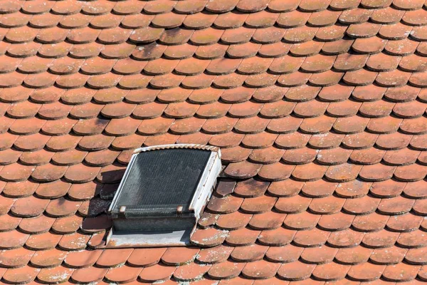 Old roof with shingles and roof windows
