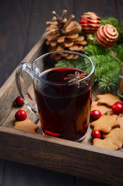 Noel mulled şarap. Tatil kavramı çam dalları, Gingerbread çerezleri ve koyu ahşap tepsi Cranberries ile dekore edilmiş.  