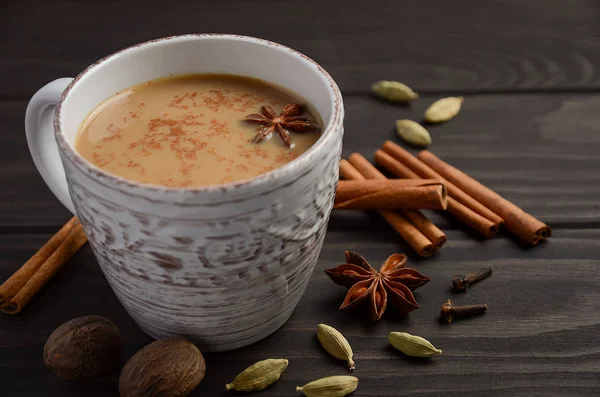 Indisk masala chai te. Kryddat te med mjölk på den rustika träbord. — Stockfoto