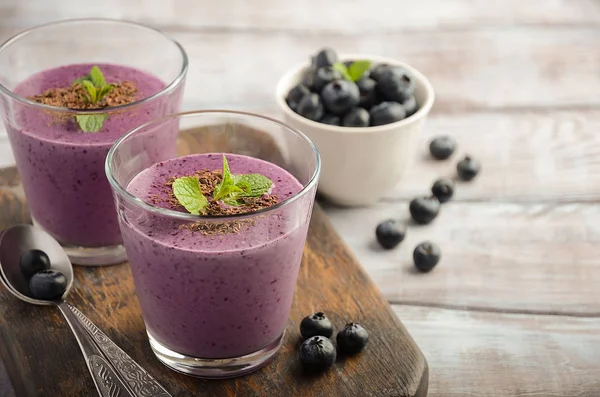 Blåbär och banan smoothie med havregryn på den rustika träbord — Stockfoto