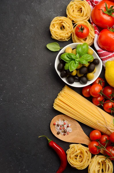 Pasta, vegetables, herbs and spices for Italian food on black background — Stock Photo, Image