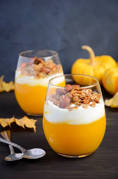 Pumpkin dessert with yogurt and homemade granola on dark wooden table — Stock Photo, Image