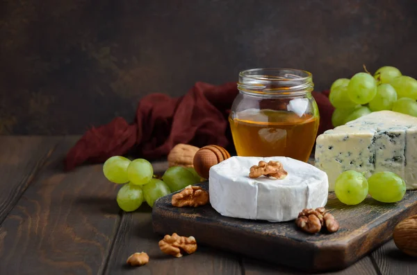 Varietà di formaggio con uva, noci e miele . — Foto Stock