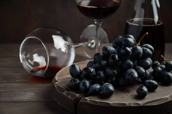 Fresh Black Grapes and Red Wine on Wooden Table Royalty Free Stock Photos