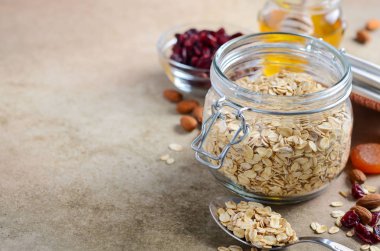 Ev yapımı yulaf ezmesi granola için malzemeler. Yulaf gevreği, bal, badem fındık, kurutulmuş cranberries ve kayısı. Sağlıklı kahvaltı konsepti.