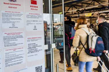 Berlin, Germany - February 3, 2020: Information in German, English and Chinese languages about the Novel Coronavirus 2019-nCoV displayed at the Schnefeld airport
