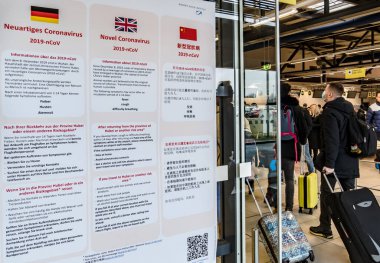 Berlin, Germany - February 3, 2020: Information in German, English and Chinese languages about the Novel Coronavirus 2019-nCoV displayed at the Schnefeld airport