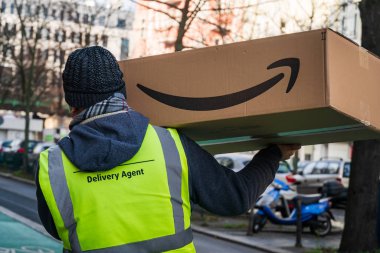 Berlin, Germany - January 27, 2020: Amazon Prime delivery agent during his work shift. Amazon is an American electronic online commerce company