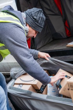 Berlin, Germany - January 27, 2020: Amazon Prime delivery agent during his work shift. Amazon is an American electronic online commerce company