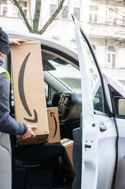 Berlin, Germany - January 27, 2020: Amazon Prime cardboard boxes in a white delivery van