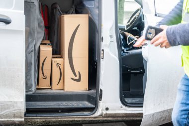 Berlin, Germany - January 27, 2020: Amazon Prime cardboard boxes in a white delivery van