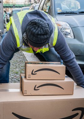 Berlin, Germany - January 27, 2020: Amazon Prime delivery agent during his work shift. Amazon is an American electronic online commerce company