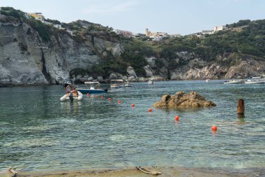 Ponza, Italy - August 25, 2019: Moored sail boat and rubber boat in the blue Tyrrhenian sea