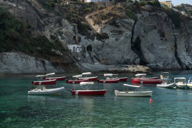Ponza, Italy - August 25, 2019: Sail boats and rubber boats moored in the blue Tyrrhenian sea