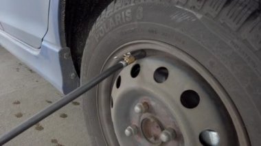 Berlin, Germany - February 29, 2020: Inflating and checking air pressure in Polaris tires