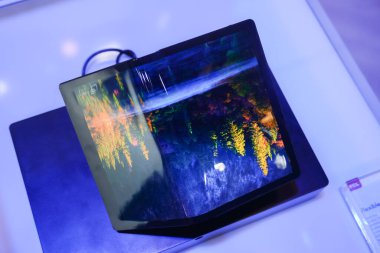 Berlin, Germany - September 10, 2019: Flexible amoled display smartphone by China Star Optoelectronics Technology (CSOT), Chinese company producing LCD panels and developing OLED technologies clipart