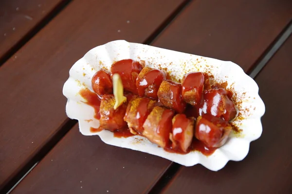 German Currywurst, fast food dish consisting of pork sausage (German Bratwurst) typically cut into slices and seasoned with curry ketchup, a sauce based on spiced ketchup or tomato paste