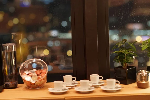 Cups and coffee capsules on wooden table. Selective focus