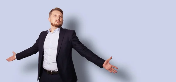 Kravat takmadan kollarını açmış yakışıklı sakallı bir adam. Gri mavi arkaplan üzerinde stüdyo resmi
