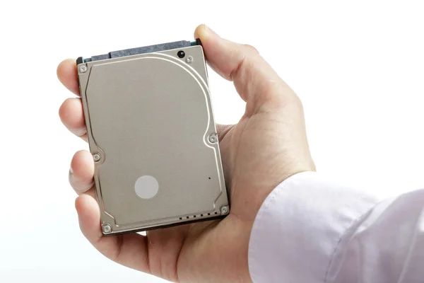 Man's hand holds a 2.5 inch hard drive. — Stock Photo, Image