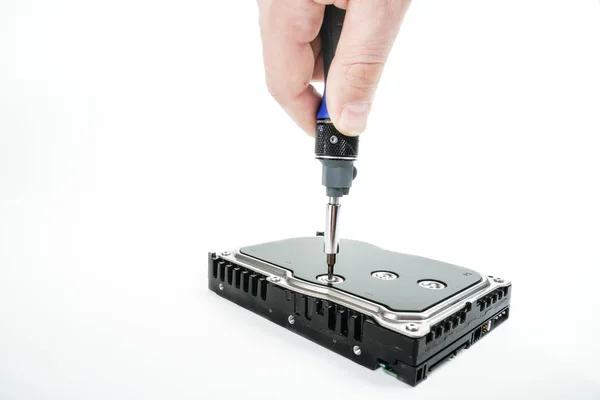 Hand repairman unscrews the 3.5 inch hard drive cover with a screwdriver. — Stock Photo, Image